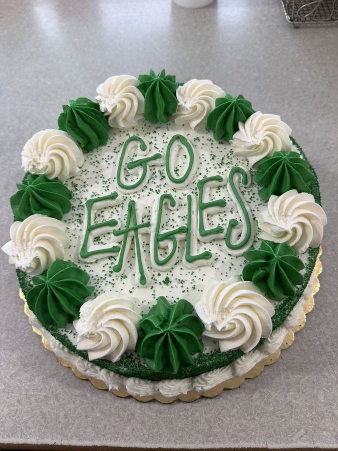 Custom-decorated Go Eagles celebration cake in green and white